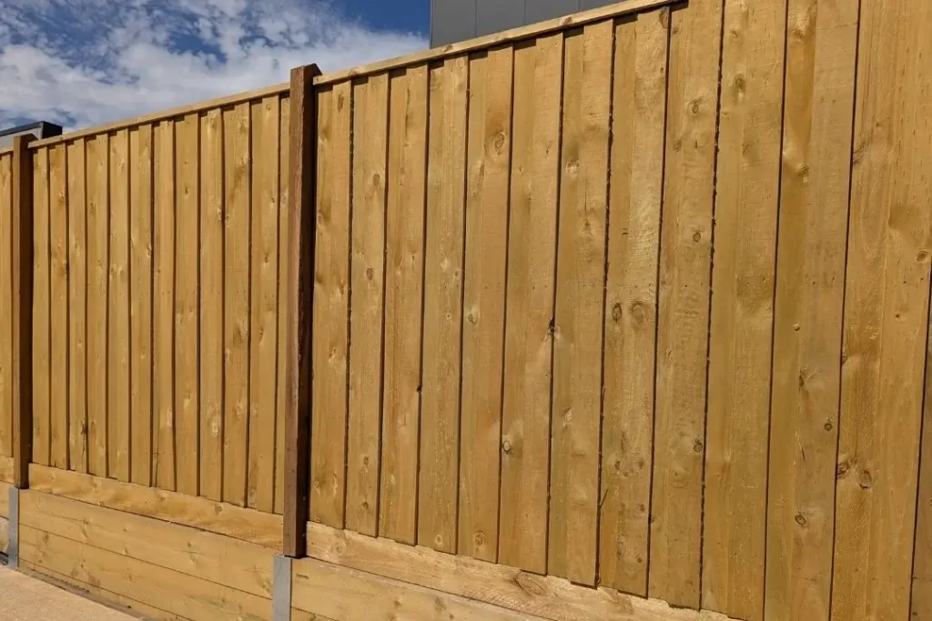 timber paling fence with retaining wall